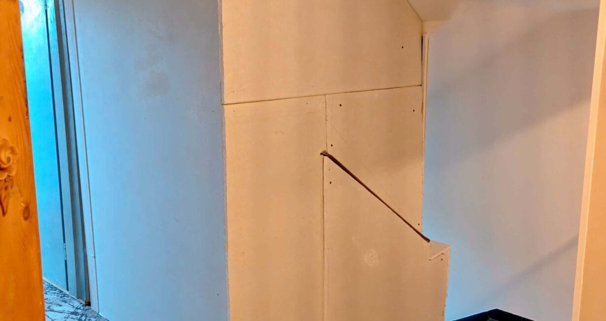 Bare plasterboard panels in the 5th-floor stairwell at Hotel Kraft Munich