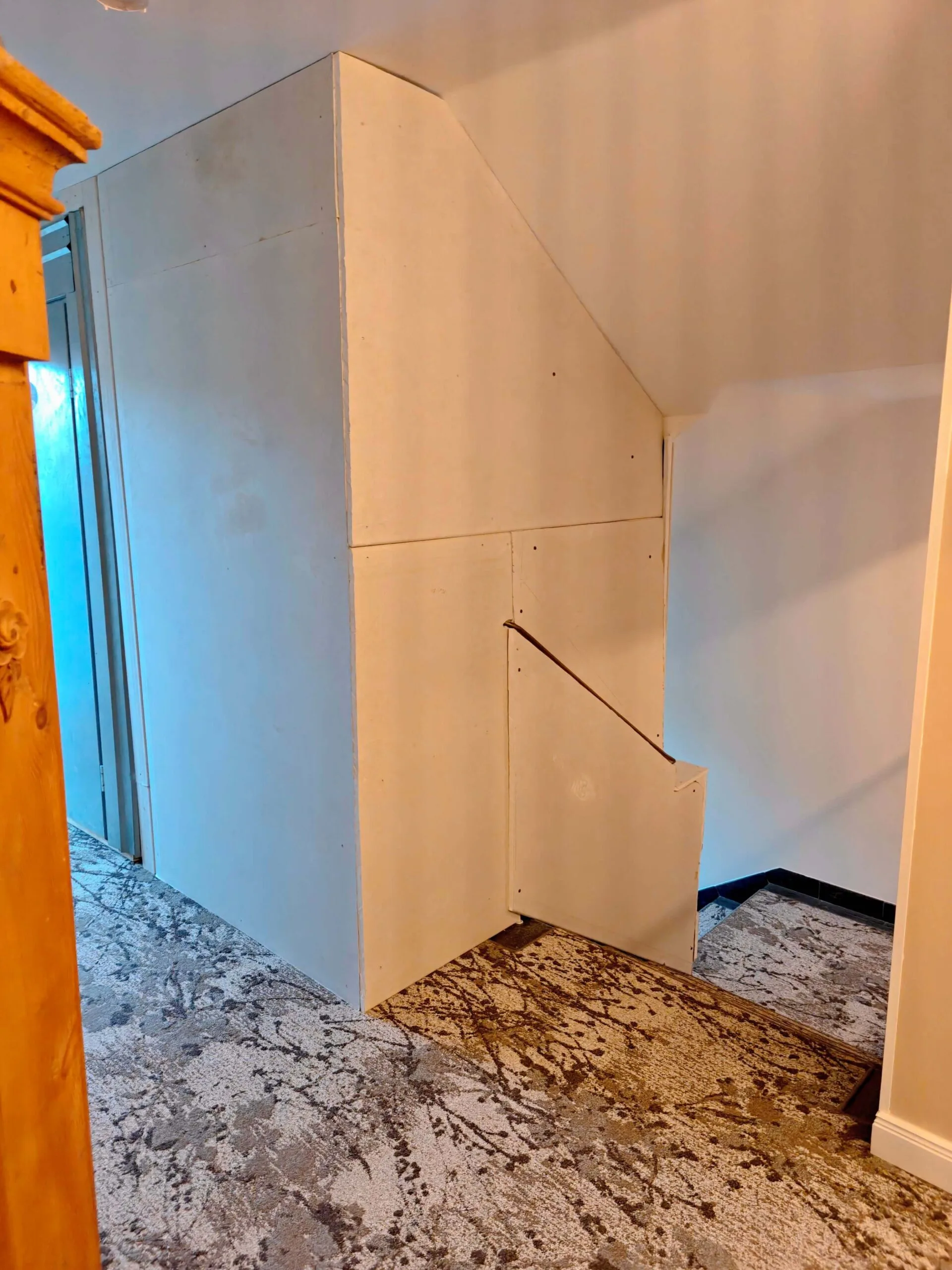 Bare plasterboard panels in the 5th-floor stairwell at Hotel Kraft Munich